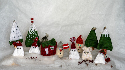 Christmas decorations from various knitted items, gnomes, snowmen, trees and houses, beautiful card, festive mood