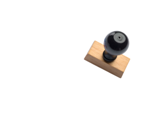 Wooden hand stamp with a glossy black handle on a solid background