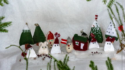 Christmas decorations from various knitted items, gnomes, snowmen, trees and houses, beautiful card, festive mood