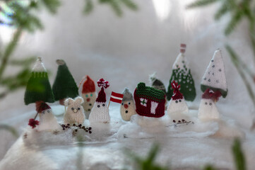 Christmas decorations from various knitted items, gnomes, snowmen, trees and houses, beautiful card, festive mood