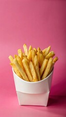 Crispy French fries stacked in a white paper box with a soft focus effect