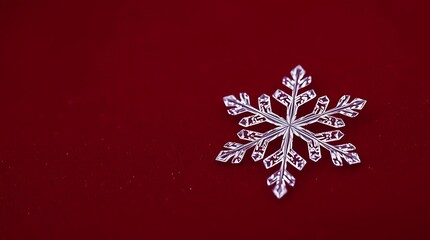 Ultra-realistic photograph of a single, perfectly formed snowflake resting on a deep red velvet fabric, showcasing intricate crystalline structure and a pristine, icy texture