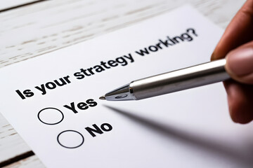 "Is your strategy working?" Question on White Paper with Check Boxes Business Concept