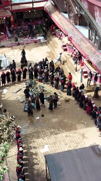 Aerial drone footage capturing the traditional Toraja Rambu Solo ceremony featuring the culturally significant buffalo cutting ritual, documenting the unique funeral tradition and heritage of Toraja