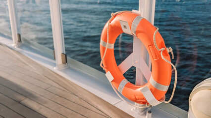 Orange Lifebuoy on a Boat Deck with Ocean View