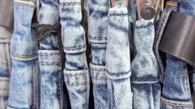 A row of faded jeans showcases denim texture and decorative folds