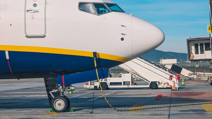 Commercial Passenger Jet Parked at Airport Gate with Boarding Equipment