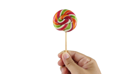 a man hand holding a sigle raibow colored lollipop