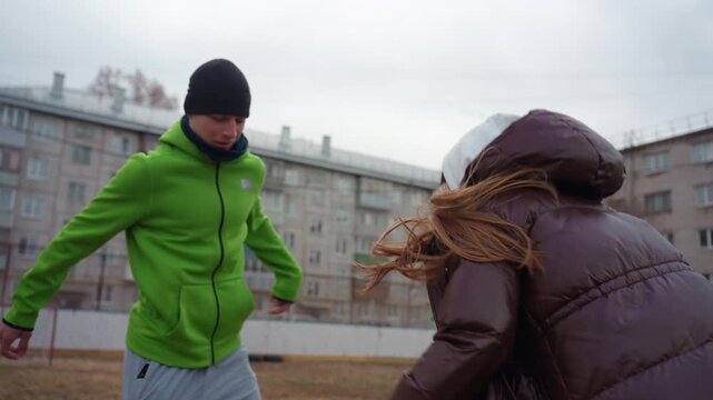 woman outplays man during game, energetic female athlete challenges male opponent in spirited match, dynamic scene of woman intercepting ball from man during lively sports duel outdoors