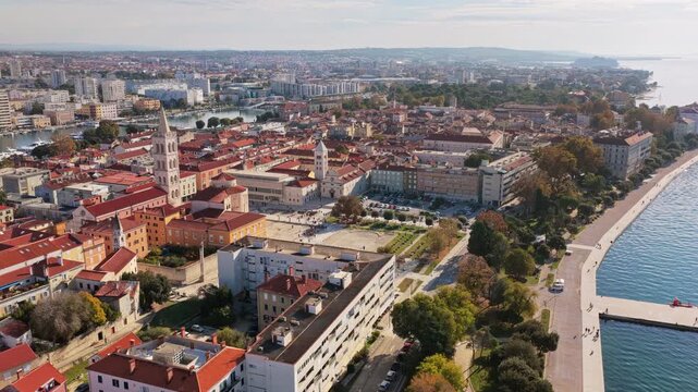 Aerial drone view of Zadar's waterfront and historic Old Town, with St. Anastasia Cathedral's bell tower prominently visible