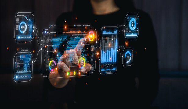 A person interacts with digital data displays, showcasing graphs and metrics, highlighting technology and data analysis in a modern setting. - Powered by Adobe