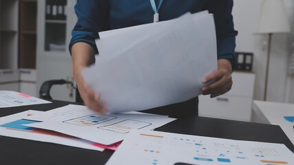 Professional woman working on UXUI design, creating wireframes and mockups for a mobile application while on a call - Powered by Adobe