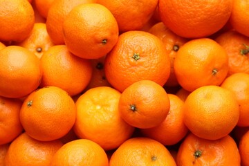 Many fresh ripe tangerines as background, top view