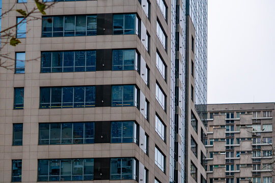 Modern residential buildings with modular facade and large windows form dense urban multifamily housing development