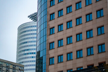 Modern office building facades in Warsaw, glass and stone surfaces of contemporary urban business architecture