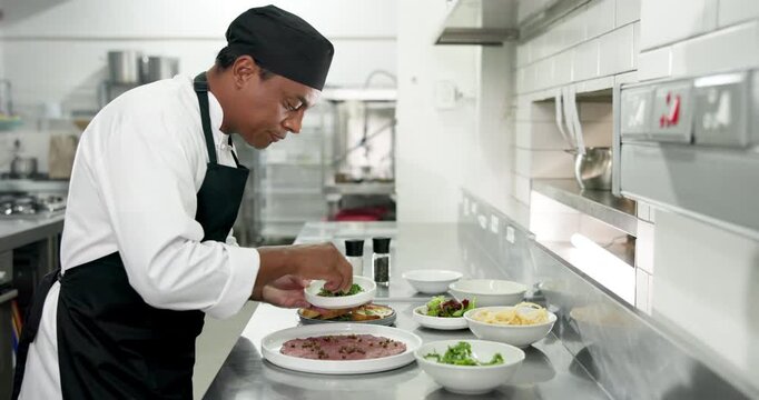 Food, presentation and man with garnish, kitchen or culinary skills for meal prep, chef and process. Plating, cook and person with ingredients for cuisine, fine dining and hospitality in restaurant