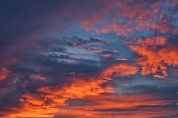 Incredibly picturesque sky and dramatic clouds in the morning, colored by the intense red of the rising sun.