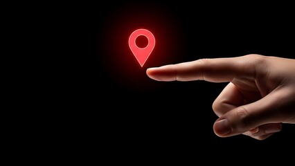 Hand pointing at red location pin on black background