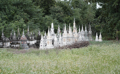 Row of buddhist tombstones on the old cemetery at temple Thailand.