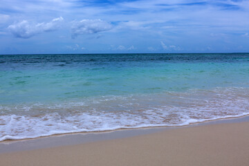 Caribbean Sea beach with white sand and clouds sky.