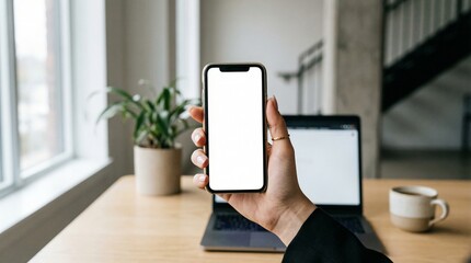 Businessperson holding smartphone with blank screen in modern office