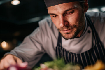 A chef skillfully preparing dishes in a restaurant.