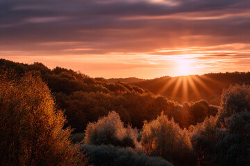 Autumn landscape at sunset warm hues of orange.