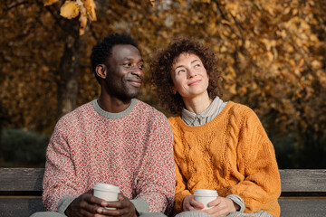 A multiethnic couple, a man and a woman, enjoying autumn.