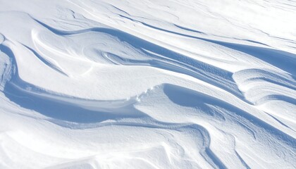 Close-up view of pristine, wind-sculpted snow drifts with soft shadows