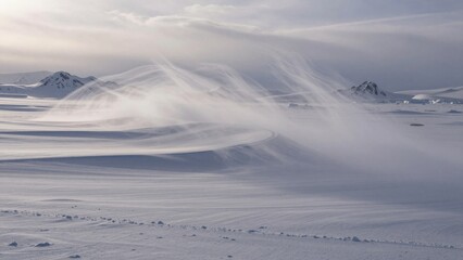 Snow and wind create patterns in the winter landscape during daylight on a cold day in a remote area