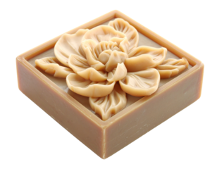 Artisanal soap carving in a wooden dish on white