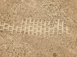 During the day, a tire track was left in the beach sand.
