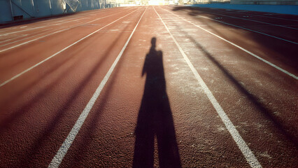 Ultra-realistic rear-angle image of runner accelerating into curve of outdoor track