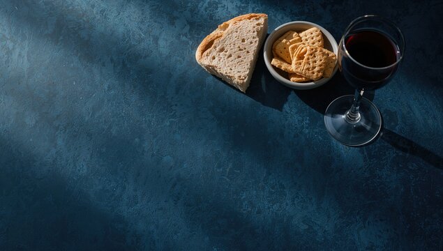Religious ceremony with Holy Communion placed on a deep blue background under natural light