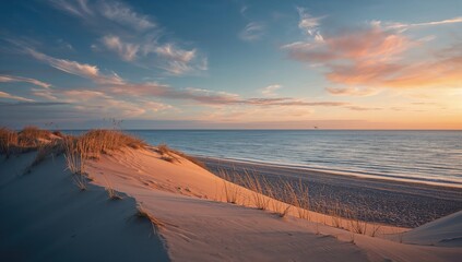 Beach landscape with sandy hills and ocean at sunset, illustrating erosion and seasonal shift