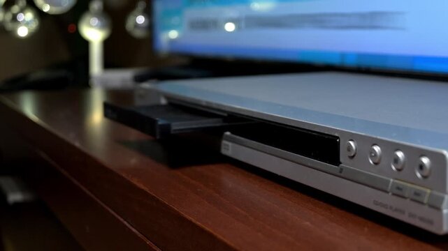 man inserting a cd into cd player