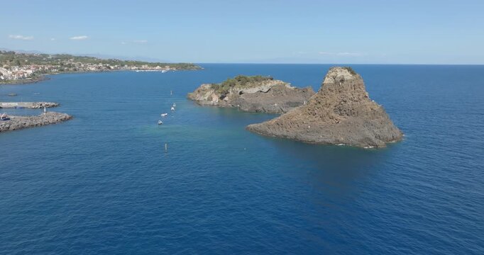 Aerial view of the Cyclopean Isles, noted for their rows of basaltic columns piled one above another, lie not far from Aci Trezza off the eastern coast of Sicily in the Mediterranean Sea, Italy. 