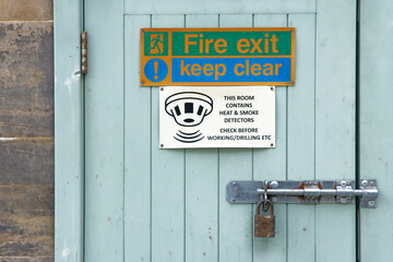 Fire exit keep clear sign on construction building site door