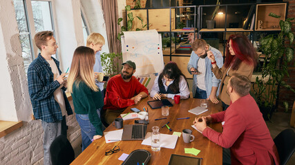 Creative team collaborating in modern coworking office. Concept of startup teamwork, open workspace culture, innovation mindset and collaborative business environment.