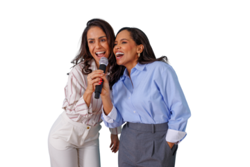 Two cheerful women singing into a microphone, expressing happiness and fun while enjoying a karaoke moment together