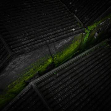Aerial view of mossy roofs create a vibrant green river flowing through the dark, textured landscape, Hoi An, Vietnam