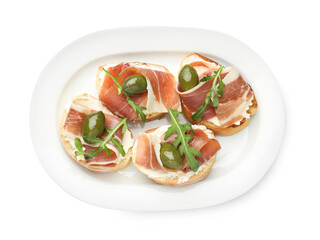 Delicious bruschettas with cream cheese, prosciutto, green olives and arugula isolated on white, top view