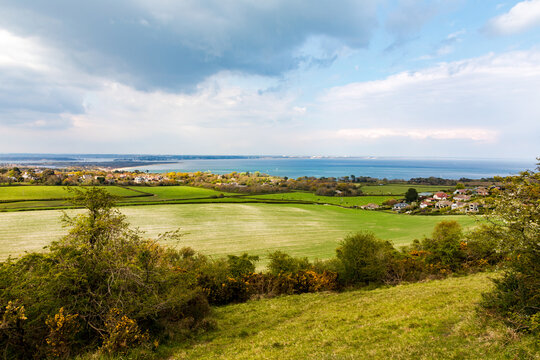 Swanage. Ballard Cliff path. Tranquil coastal countryside overlooking Studland village fields and blue sea horizon