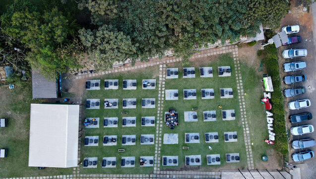 Aerial view of a meticulously arranged outdoor event space, with uniform seating contrasting against the vibrant green lawn, Abuja, Federal Capital Territory, Nigeria.