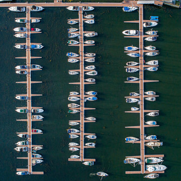 Aerial view of boats neatly docked in the marina, creating a rhythmic pattern against the dark water, Atlantic City, New Jersey, United States.