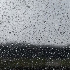 Beautiful raindrops adhering to a glass surface during a gentle shower, creating a soothing and peaceful atmospheric backdrop, freshness, nice, surface
