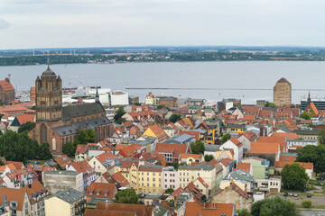 Aerial view of St. Nikolai Church and the historic cityscape meeting the expansive waters, a captivating blend of architectural heritage and natural beauty, Stralsund, Mecklenburg-Vorpommern, Germany.