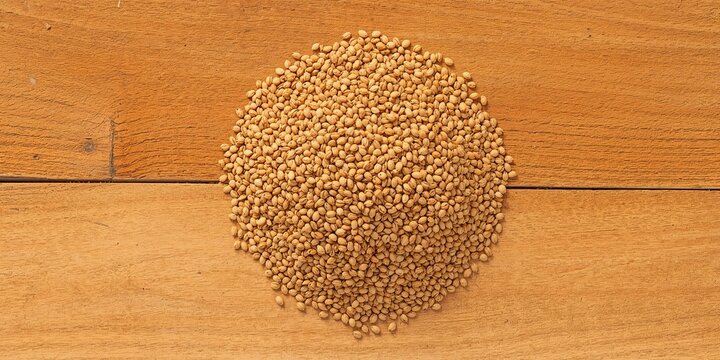 Bulgur seeds on wooden surface serving as a natural food ingredient background