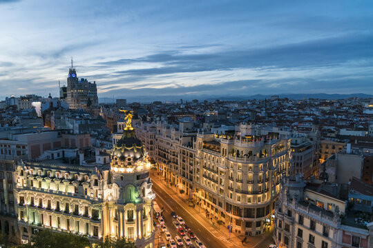 Aerial view of the illuminated Metropolis Building and the distant Telef&oacute;nica Building under the twilight sky, Madrid, Community of Madrid, Spain.