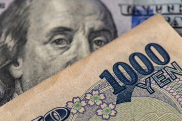 Macro of US 100 Dollar Bill and Japanese 1000 Yen Banknote Together